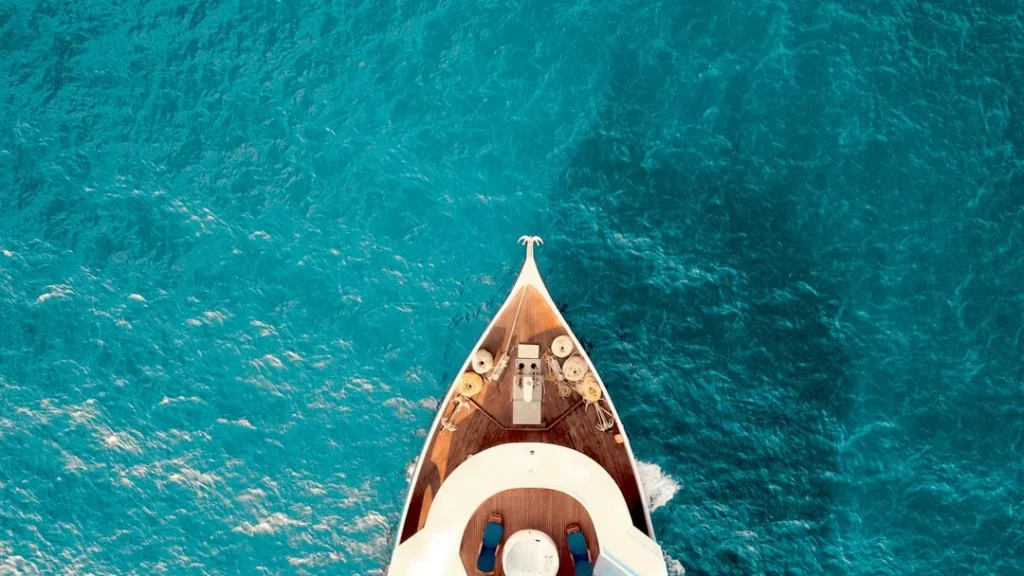 guides-aerial-view-of-a-yacht-charter-sailing-through-clear-blue-waters-near-heraklion.-sea-excursions-greece